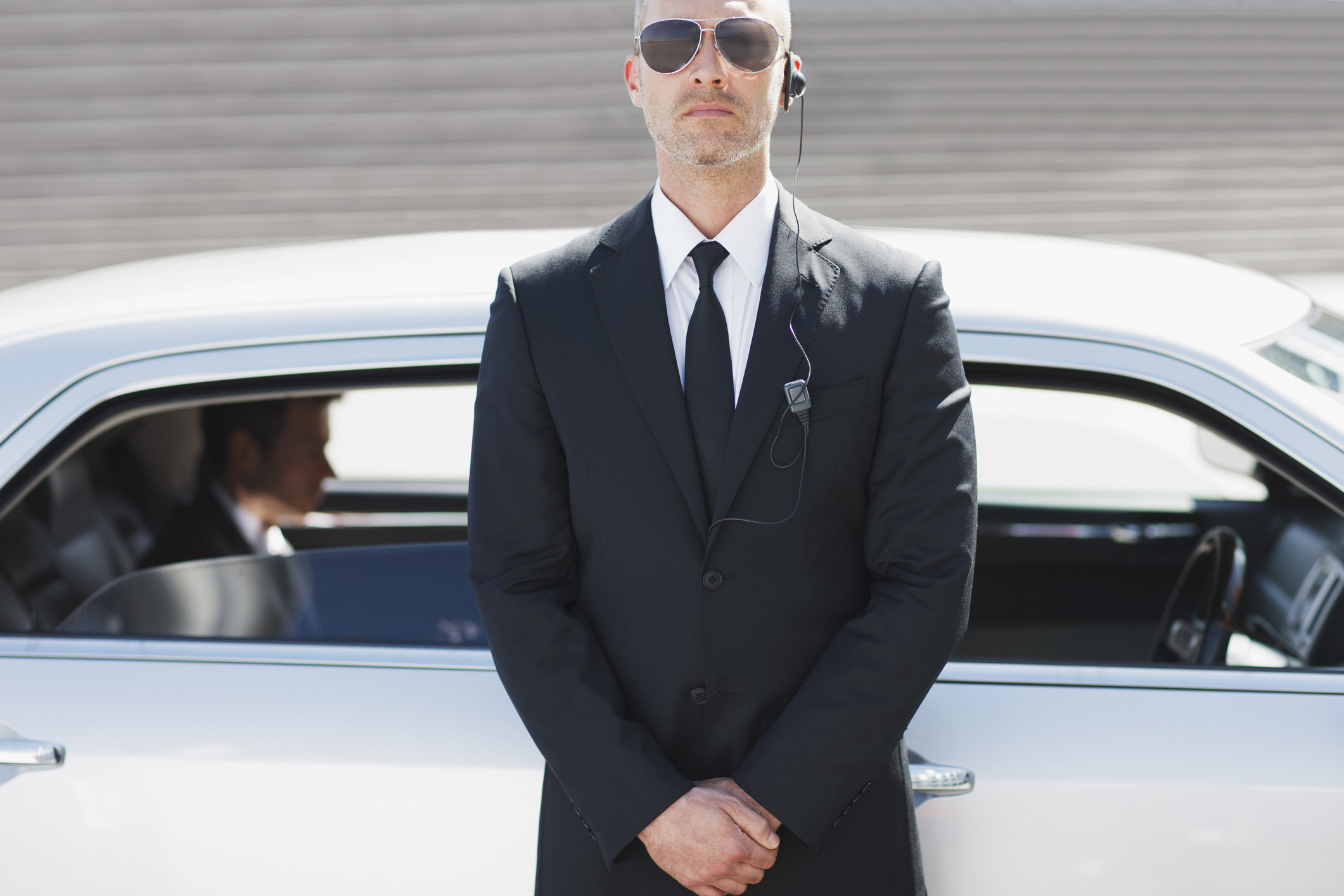 Security guard standing by car